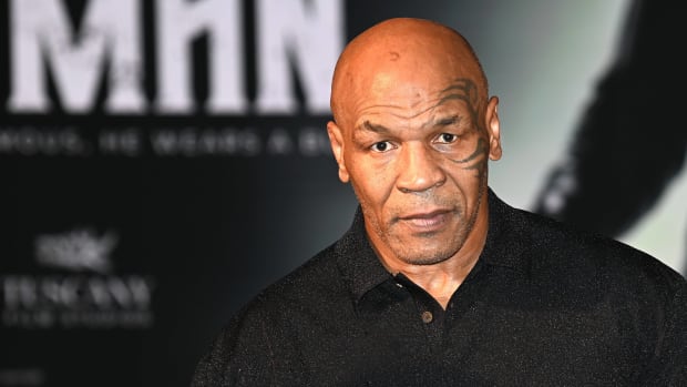 Boxer Mike Tyson looks on while speaking with media.
